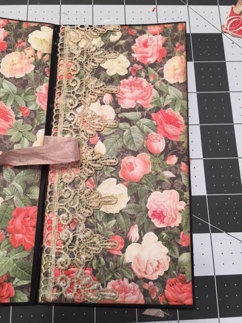 On the front cover. glue a strip of lace to the left side underneath the ribbon.