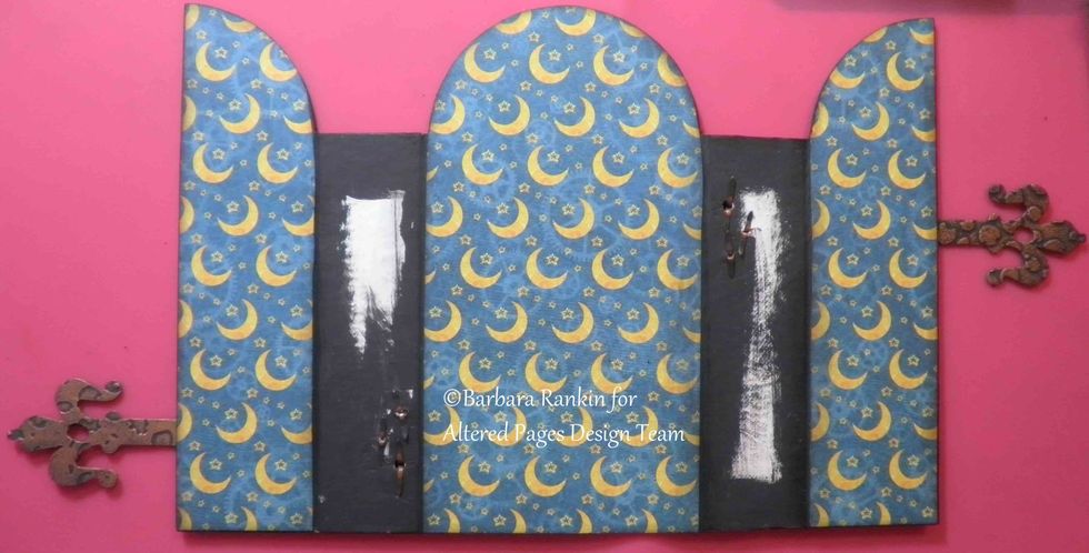 On the inside, you can see the brad prongs, which will be covered later with the page hinges.