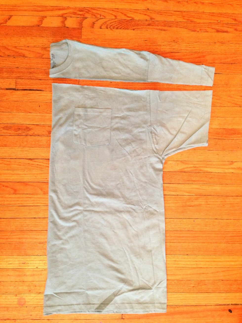 On the larger T-shirt cut straight across under the neck ribbing.