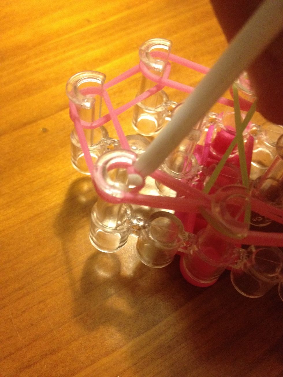 On the last pin grab the pink band and pull it to the middle Pin