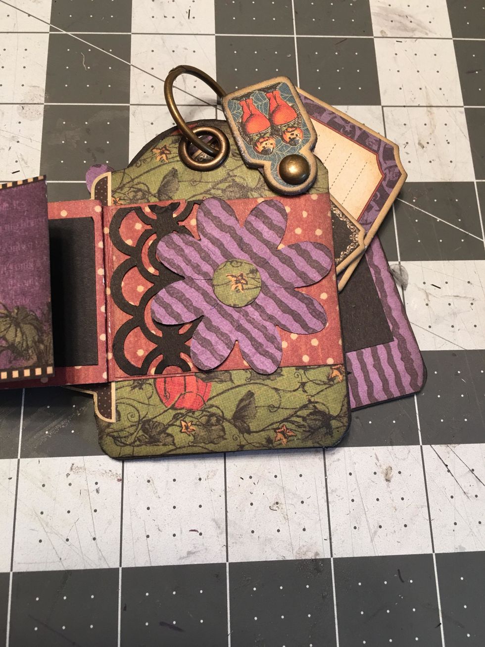 On the last section of the fold out, add patterned paper, a flower and a bit of black punched border.