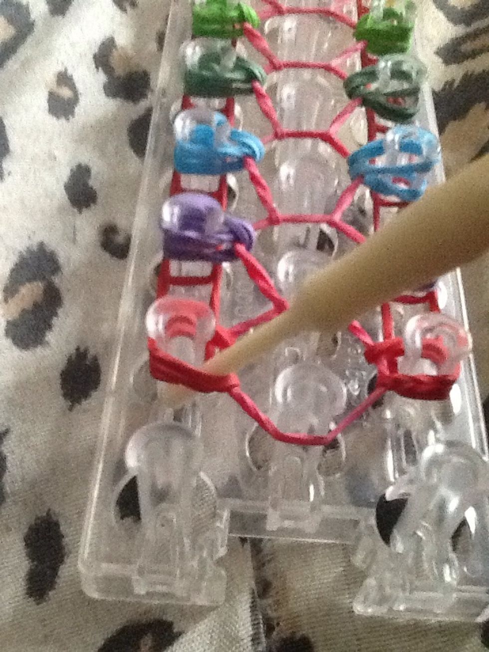 on the left, pull out the bands it get to the bottom one and loop up.