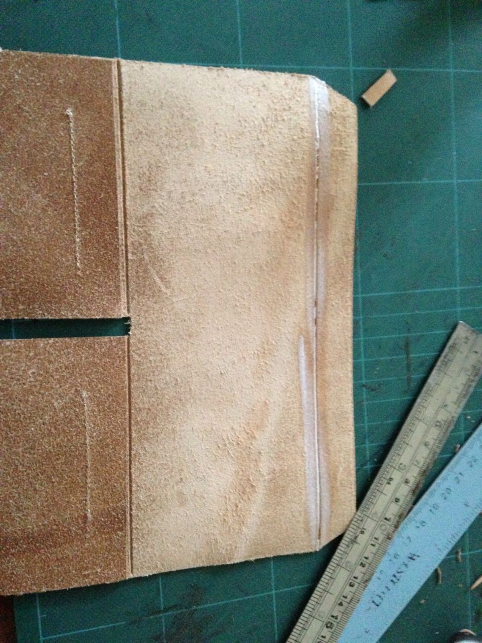 On the line that we made before spread a glue about 1cm wide across the line and then fold the leather and again pound the with your hammer untill it sticks together