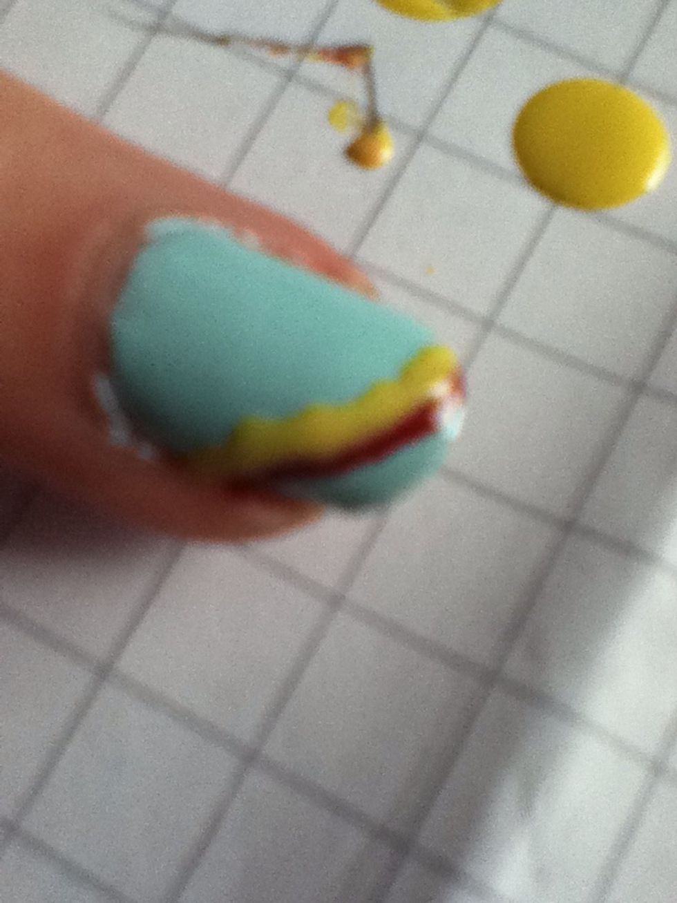 On the next nail use the pencil to make thin lines in the order of the rainbow. If they aren't too neat at the bottom it doesn't matter because you cover over it slightly with the next line.