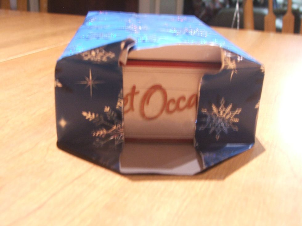 On the other side fold the Wrapping Paper toward the end of the box.