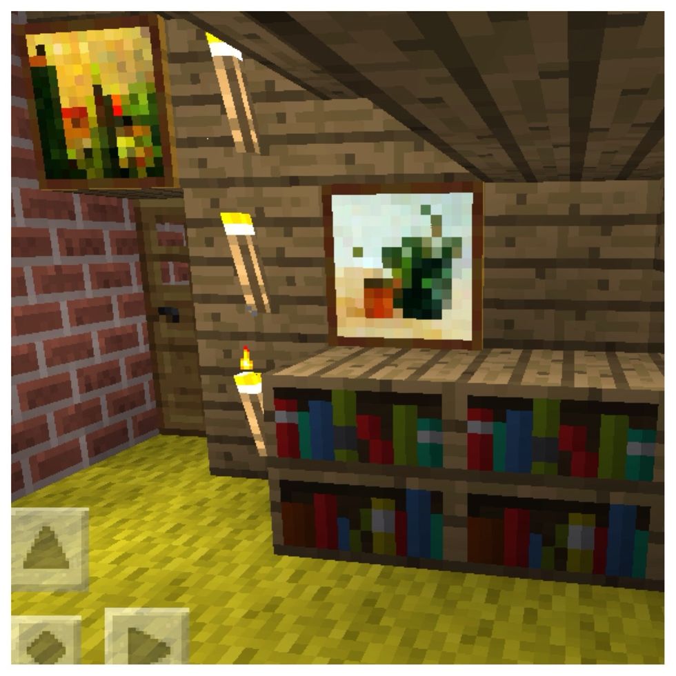 On the other side I added some bookshelves, a few torches and a couple more paintings. I also switched out grass for a yellow wool carpet.