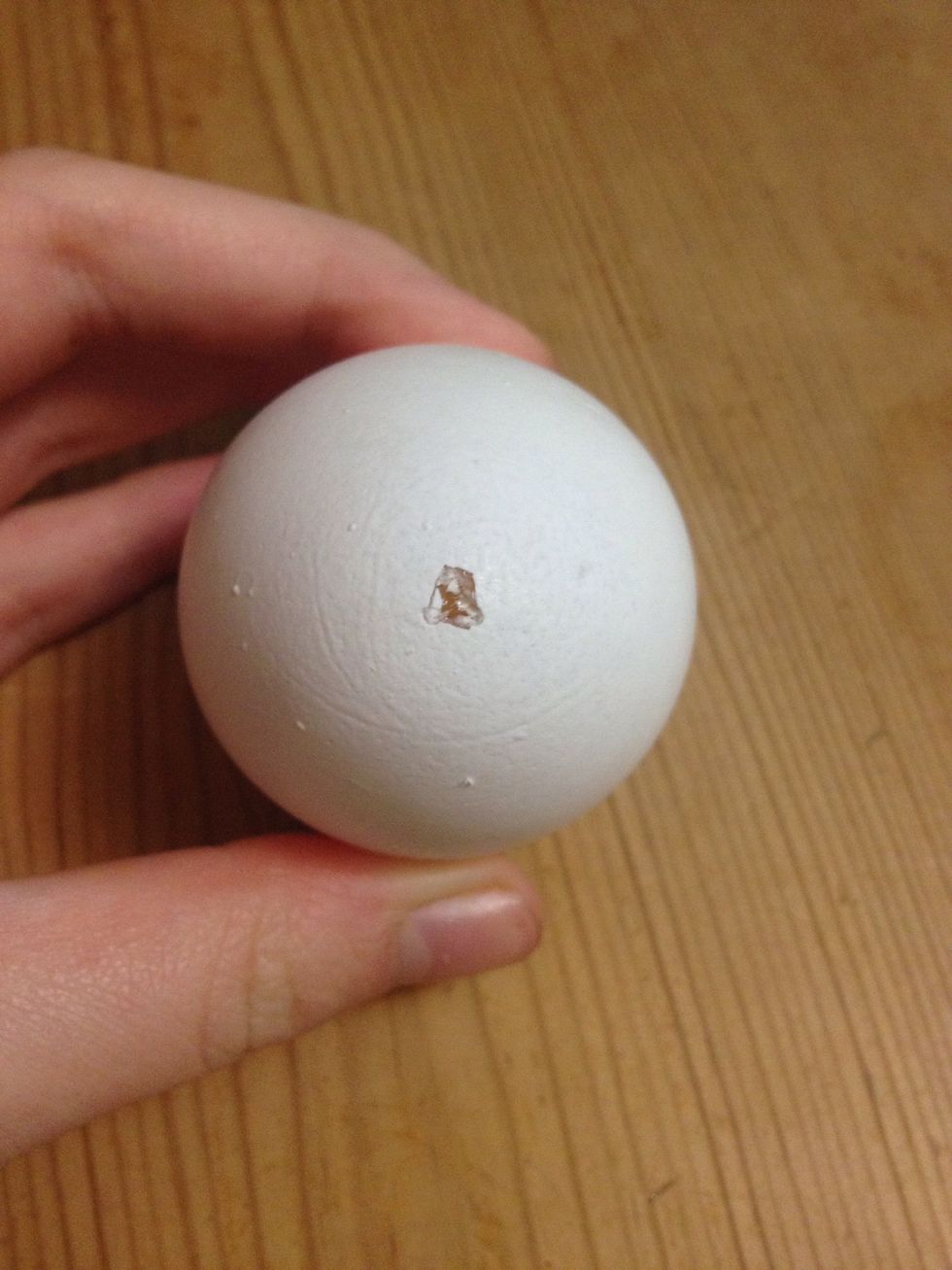 On the other side, poke three holes close together that should combine to make a little but bigger hole than on the opposite side.