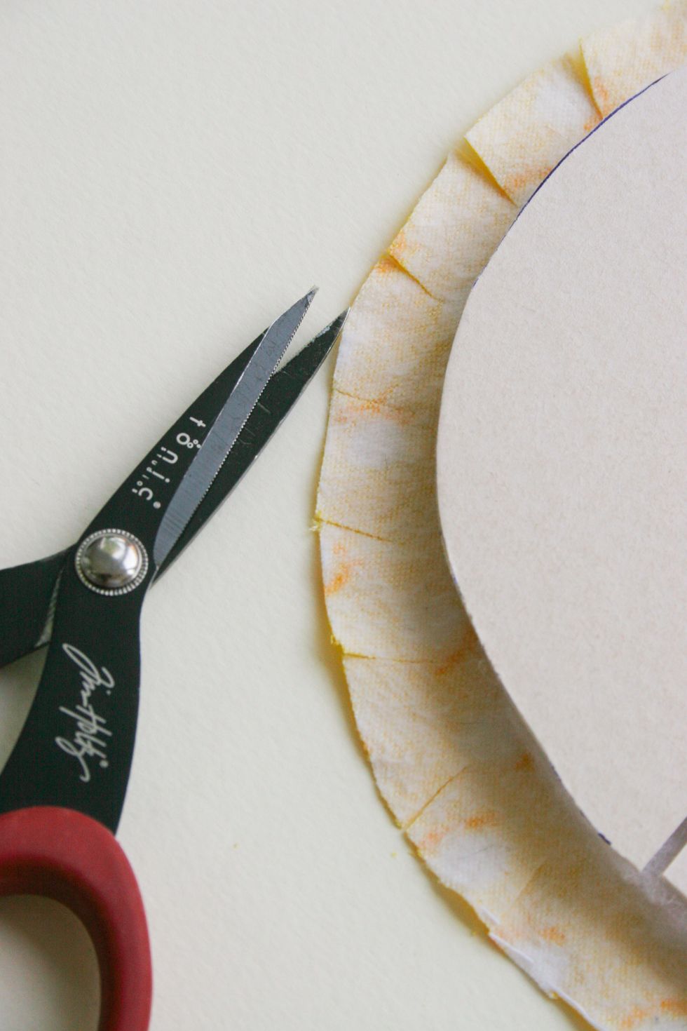 On the other side, where a round piece of cardboard, you need to make an incision in the tissue.