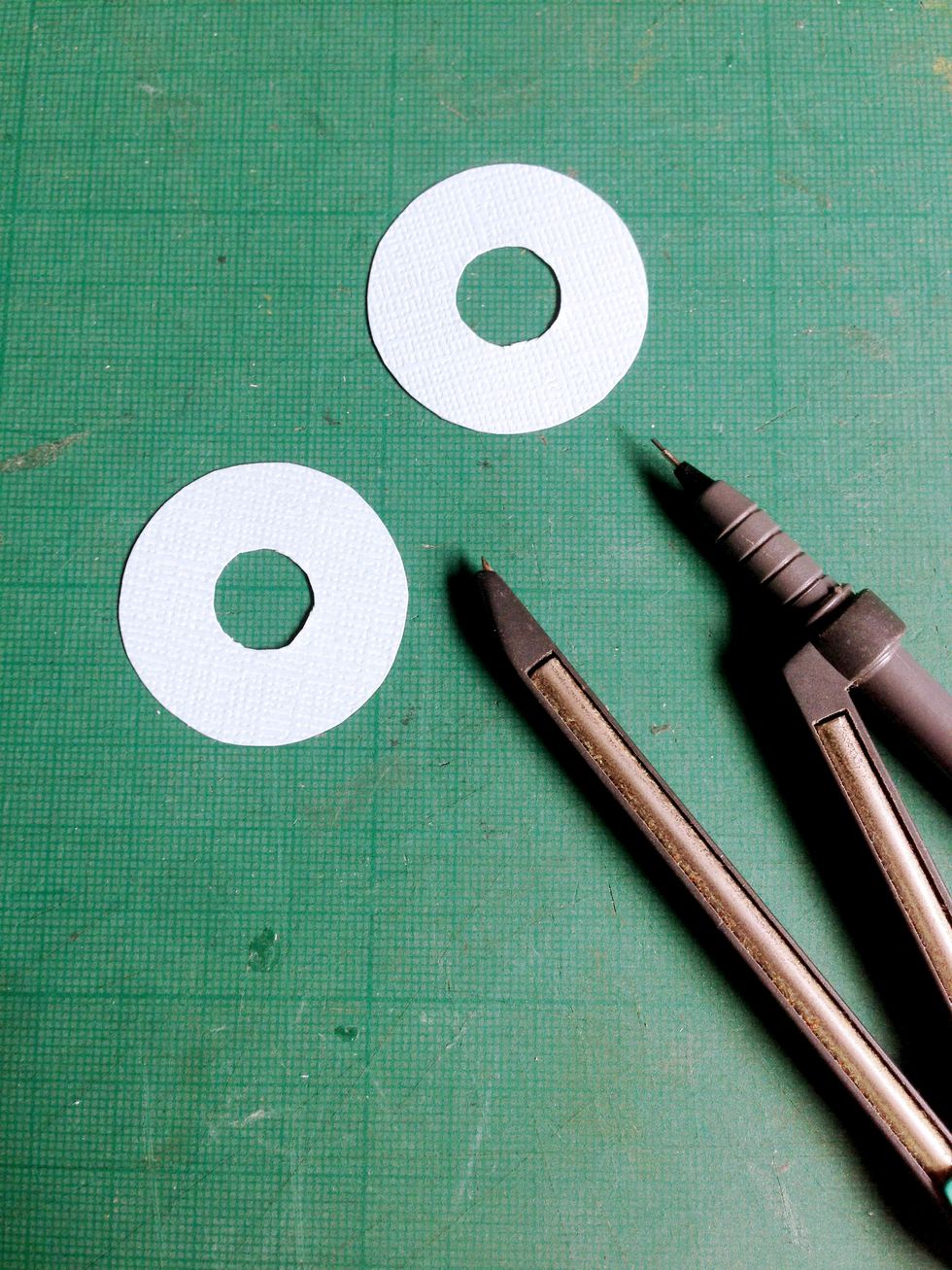 On the Robin's Egg cardstock, using a compass draw out a circle of 1.25" with a 0.5" circle at the centre... Cut them out as shown...