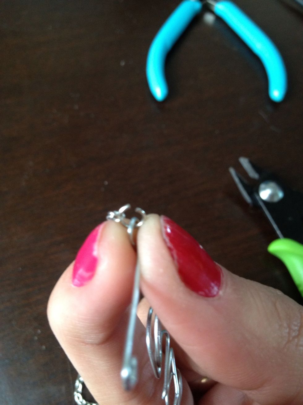 On the second loop of the L add a jump ring and chain. Measuring the chain put a jump ring and a crab claw clasp on it to clip on the E.
