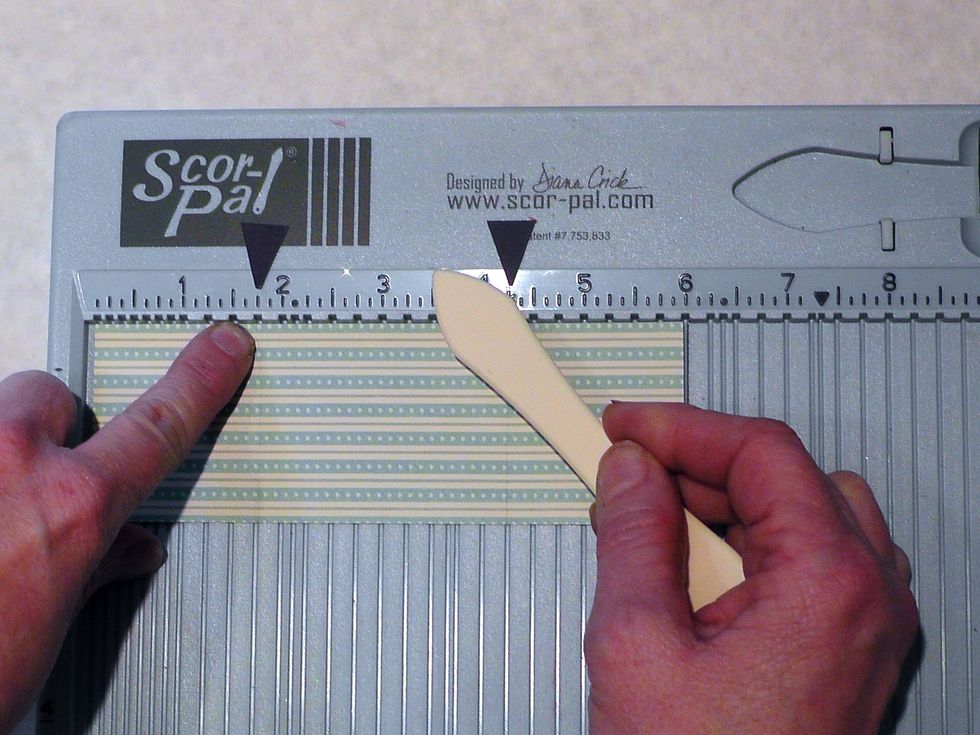 On the smaller strip, score at 1 3/4 inches in from each edge