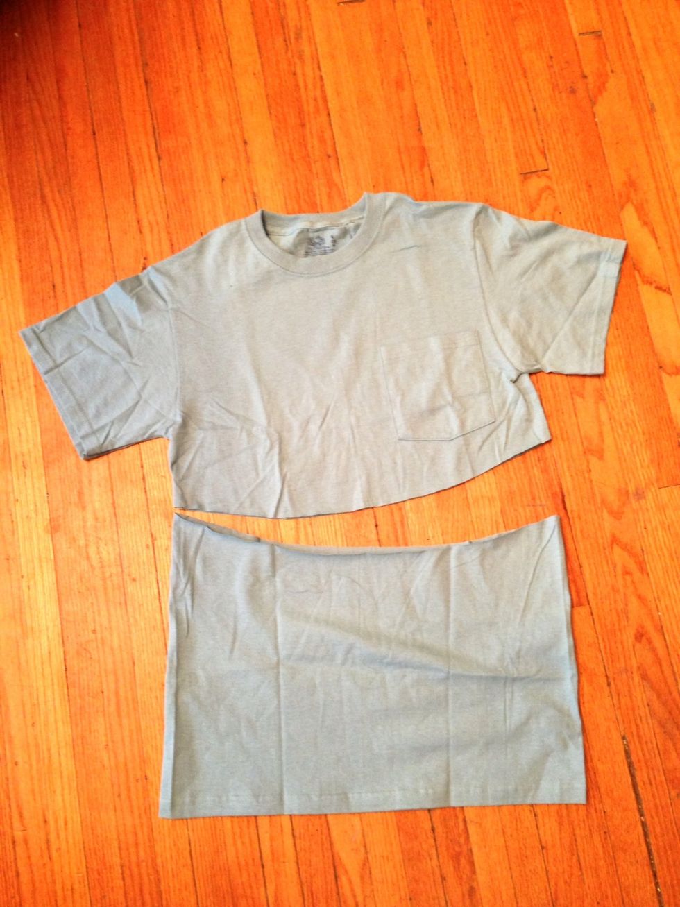 On the smaller T-shirt, cut a curved line under the breast pocket, or so the bottom of the curve hits about 2 inches below your sternum when you have the shirt on.