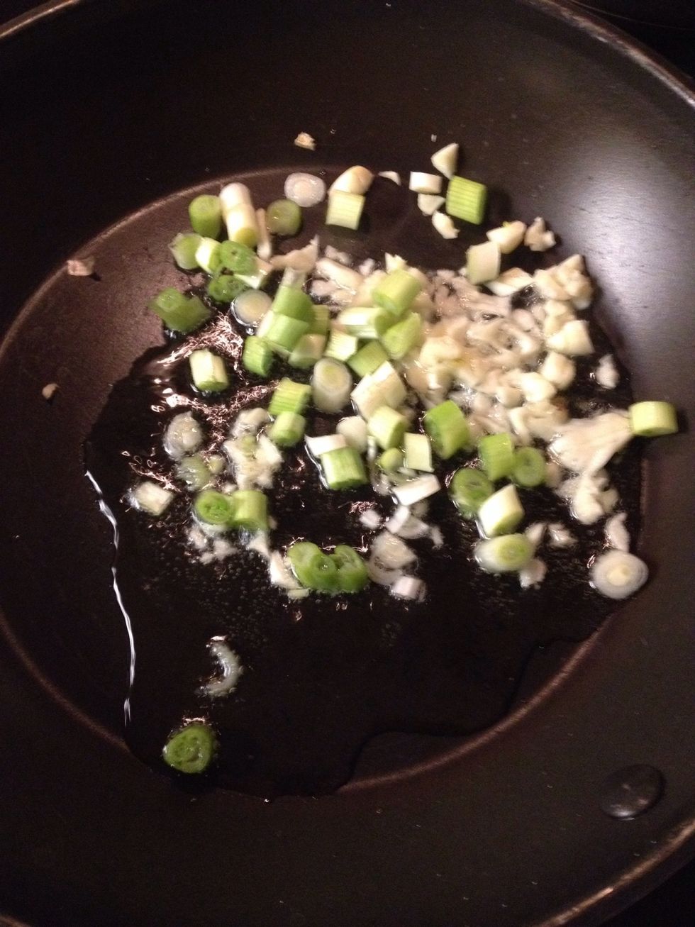 On the stove, add garlic and scallion until brown.