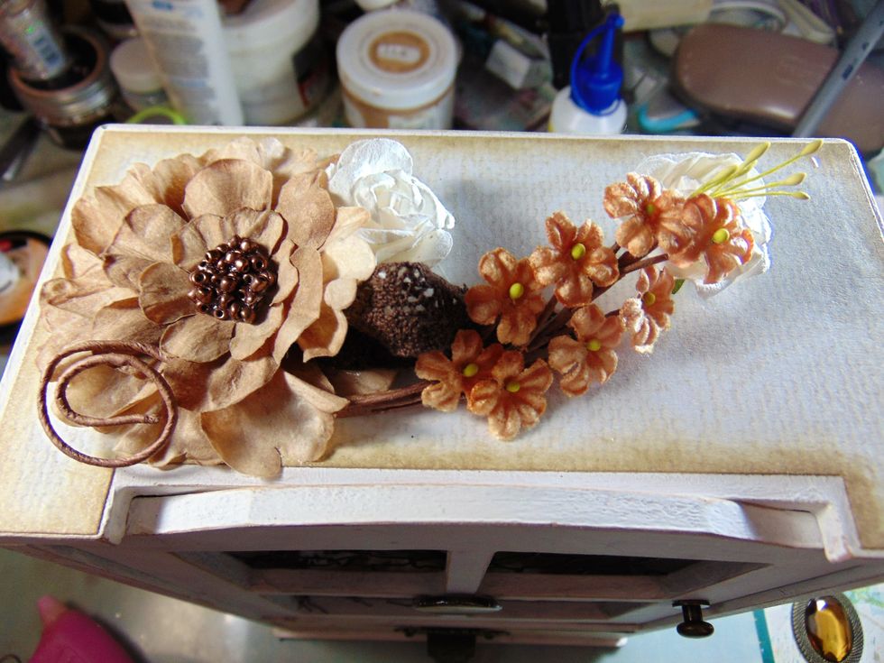 On the top of the hutch I added some flowers from the kit, a ribbon and a vine flower from a previous kit.