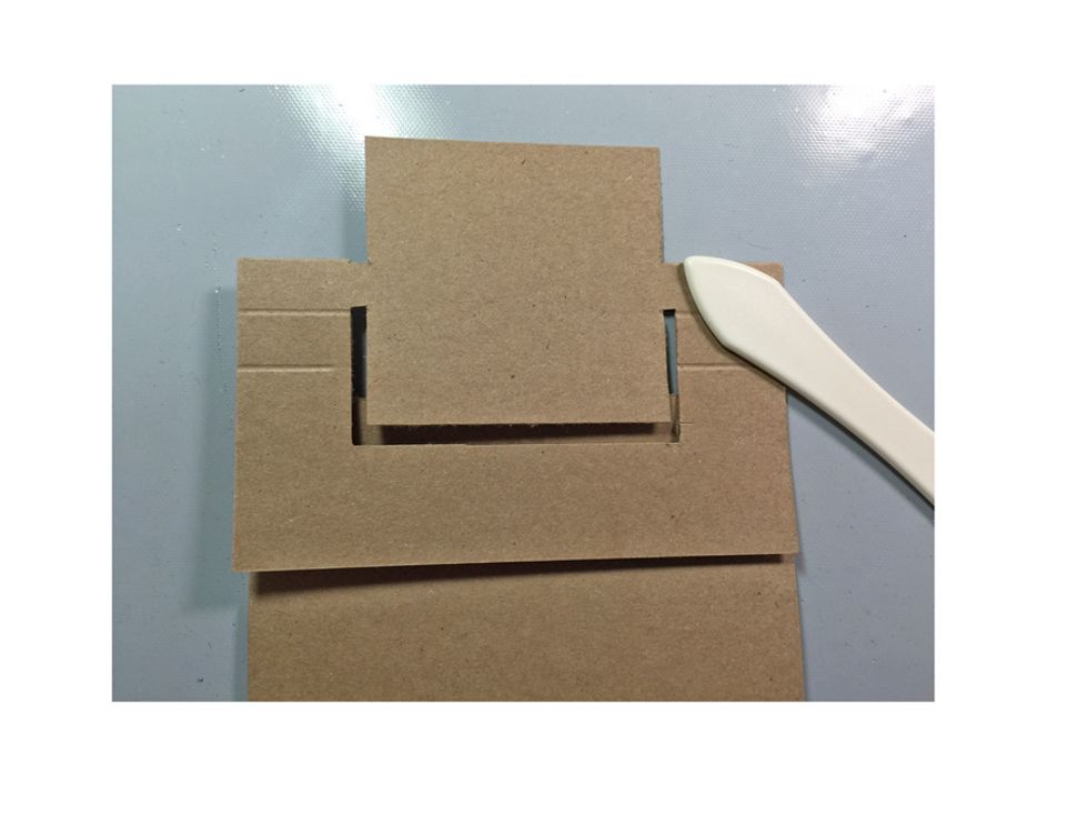 On the top score line fold down to create a mountain fold and crease with a bone folder for a sharp edge.