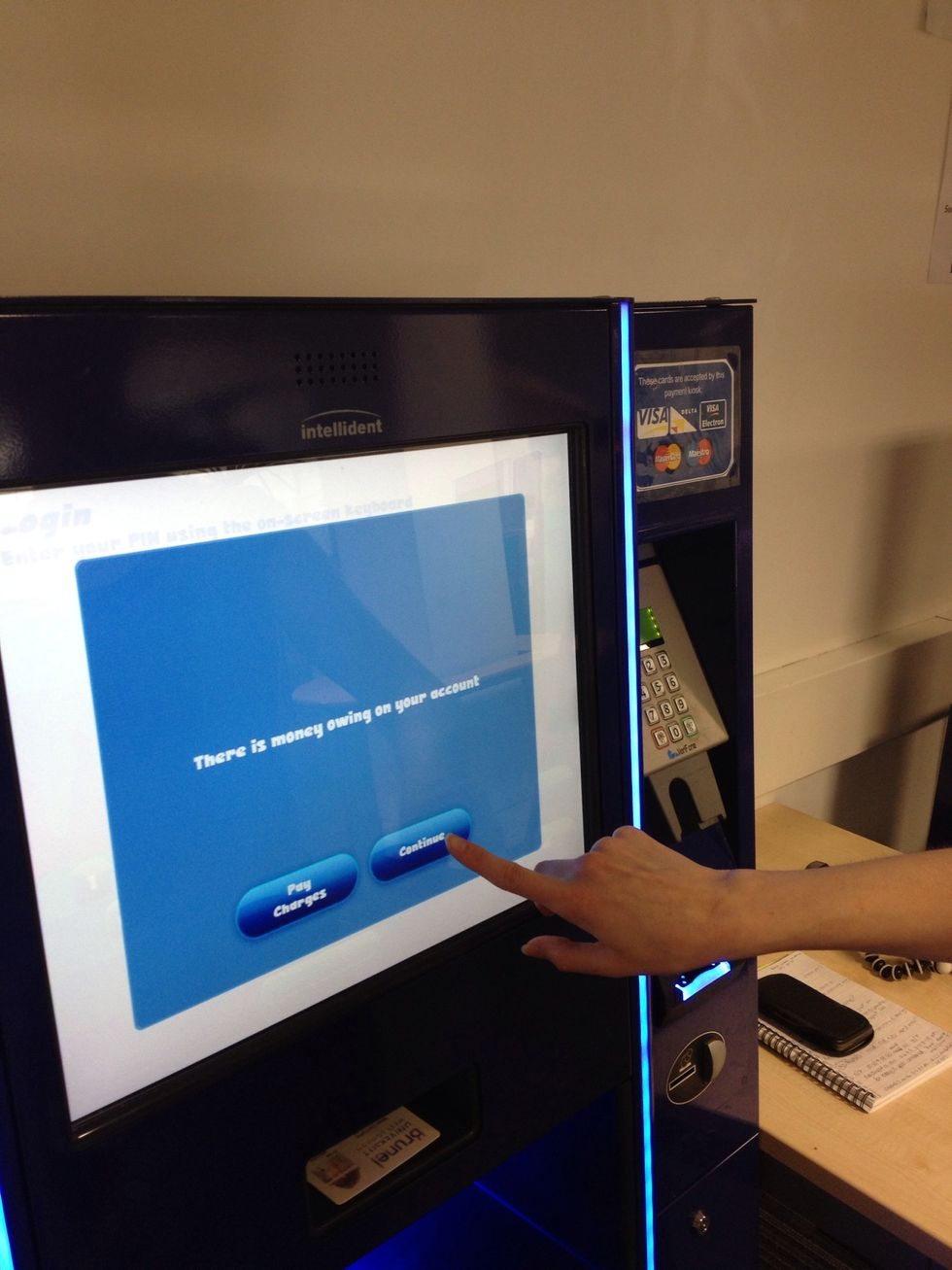 On this machine if you have fines on your account it will offer you an option to pay them now. We don't want to do that now, so we'll choose to continue.