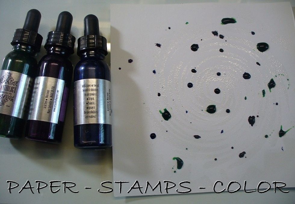 On this SECOND project: heat embossing as a resist and coloring an image.  Dab Versamark to surface over Hurricane stencil. Heat emboss with clear. Add drops of three colors Minx inks to background.