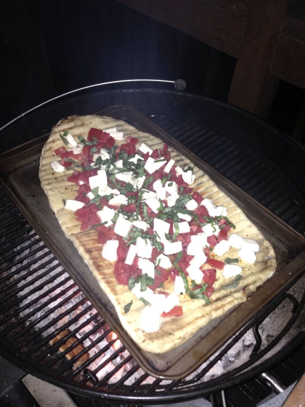 On to a baking sheet and back to the makeshift oven to finish cooking. You can gauge when it's ready by watching the crust & toppings.