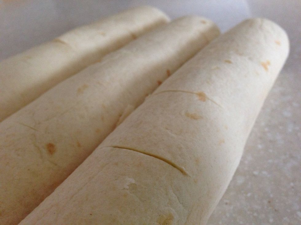 On top of all three tortillas score them each six times to let some heat out while they are in the oven.