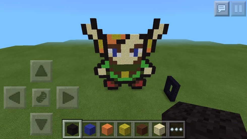 On top of the black, add two sandstones, one beside the top one, and one on top of that. Place black around it, but on the inside, put one extra black.