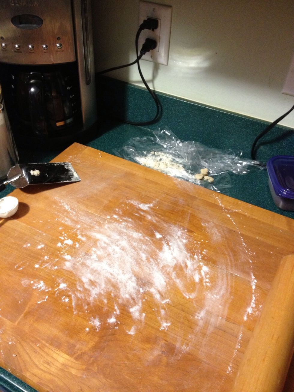 On your large board (or very clean counter) sprinkle flour out. About a tablespoon should do the trick. Then rub the flour around so that you have an even coat and no clumps.