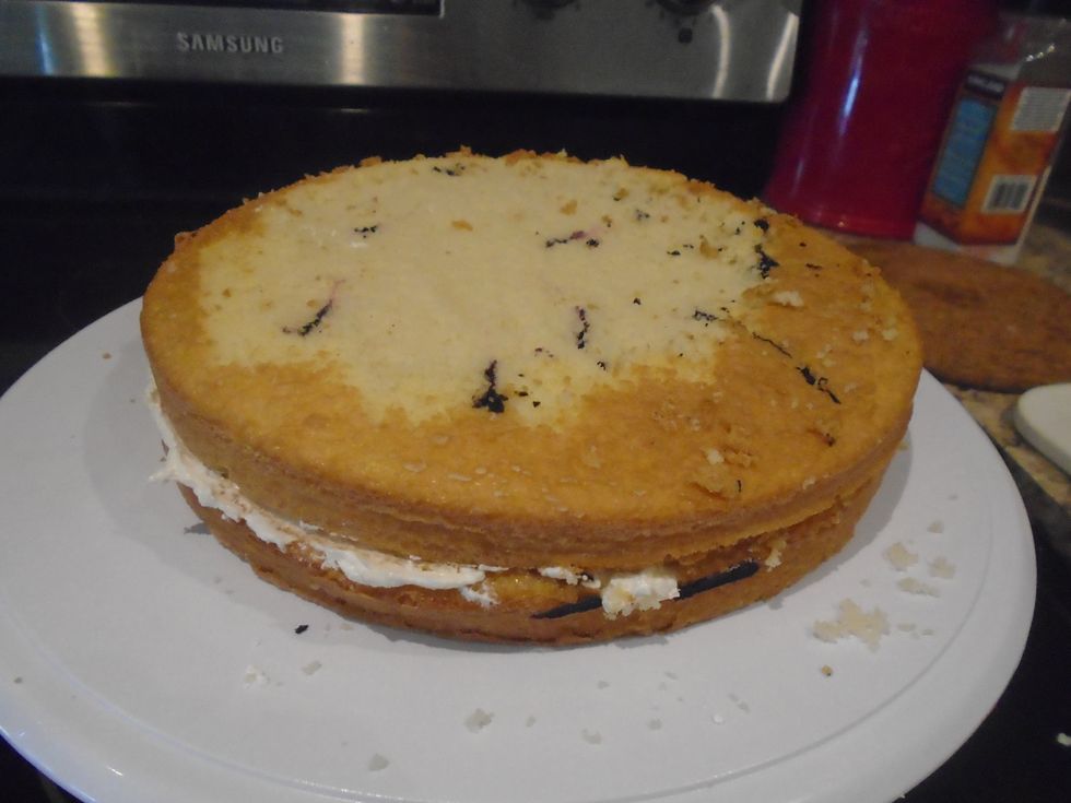 Once a thin layer is on the first cake add the second cake on top.