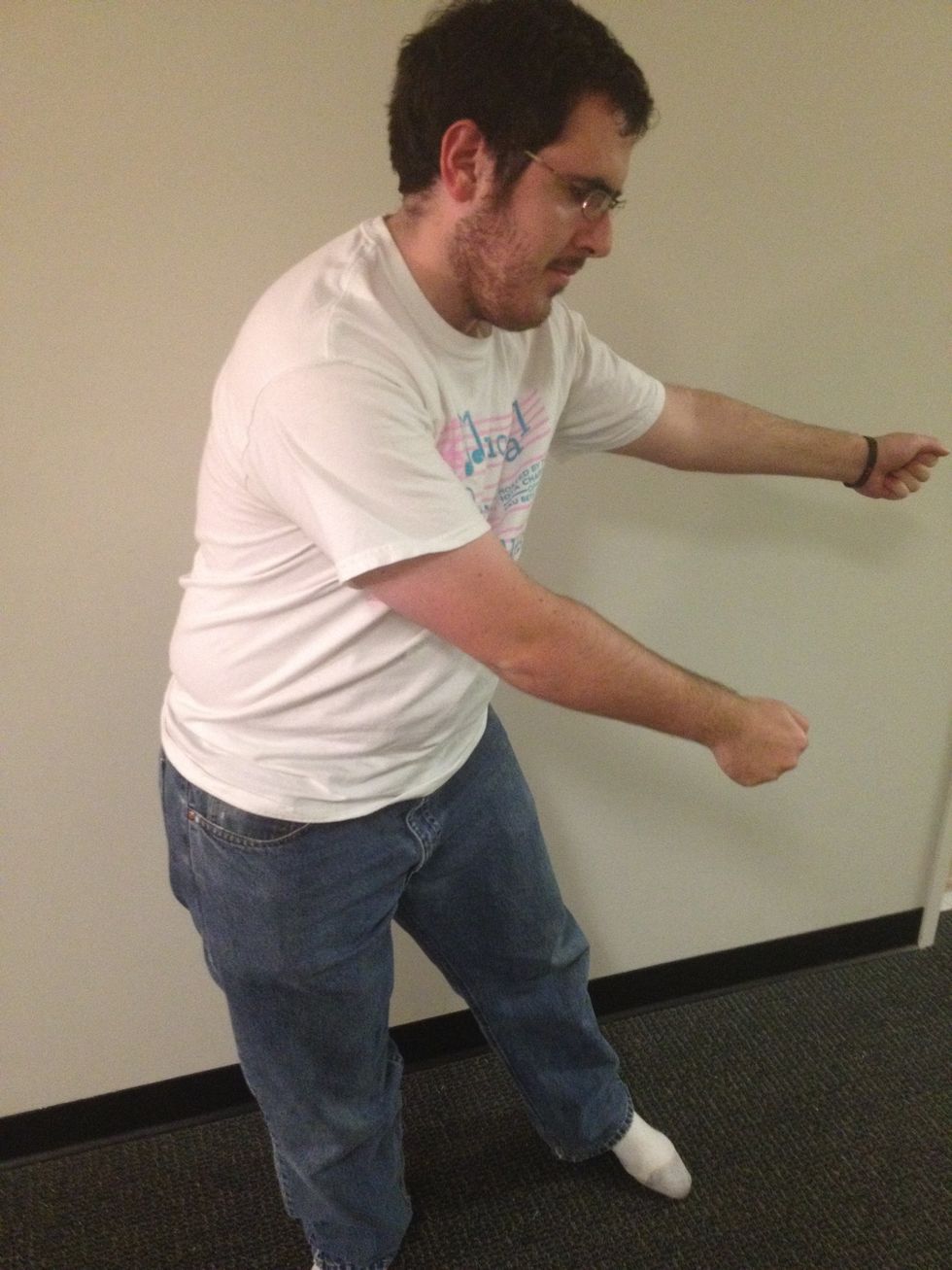 Once again, swing your arms to the right, except this time keep both arms in front of your body. At the same time, swing your hips to the left.