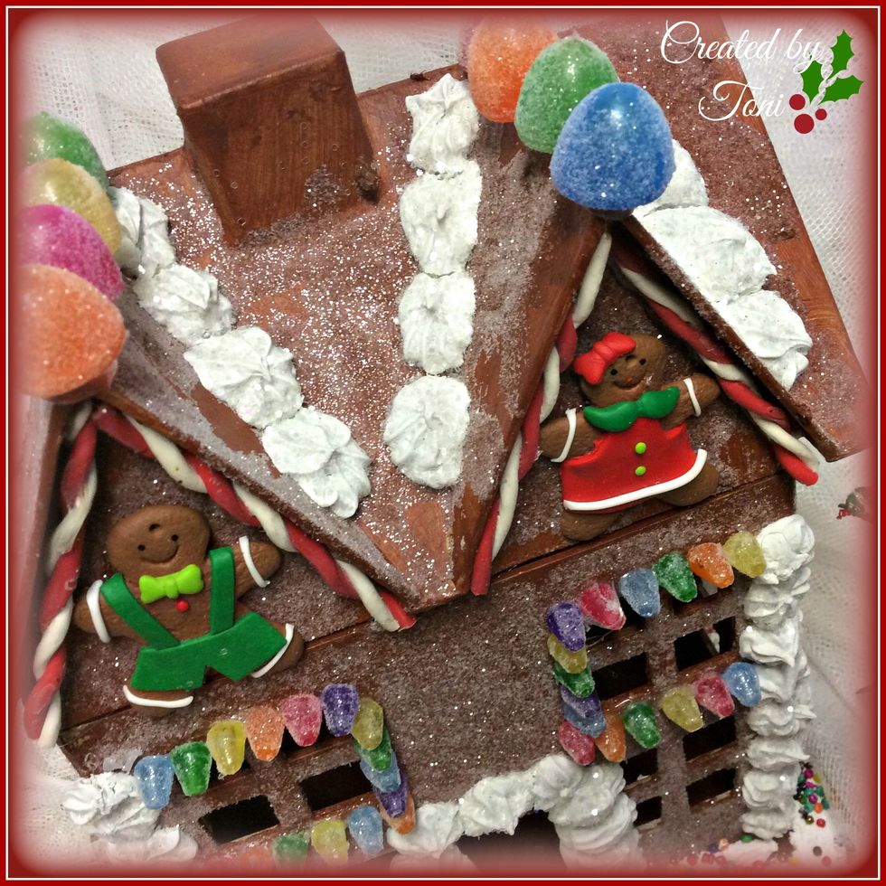 Once again the gumdrops on the roof and the gingerbread people were also ornaments for miniature Christmas trees purchased at the craft store.