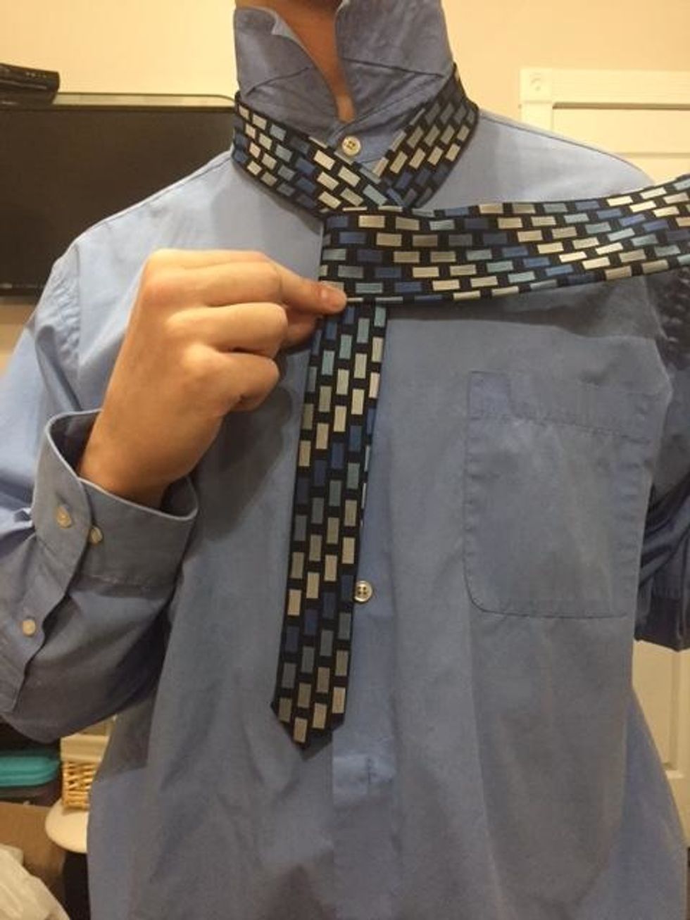 Once again, wrap the wide end over the small end.