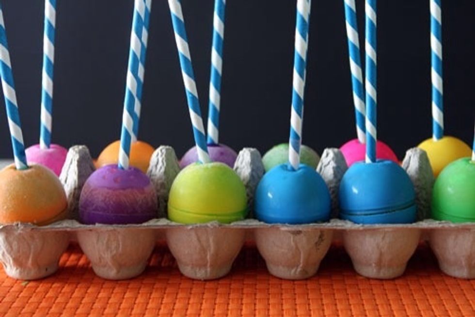 Once all eggs are a little less than full, place in egg carton, hole side up. Place straw or Popsicle stick in the hole and freeze overnight.