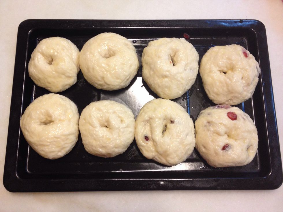 Once all the bagels are boiled, brush them with an egg wash. At this point you may add any toppings you desire. I have added cranberries to 4 of my bagels @ step 12. Bake them for 20 minutes.