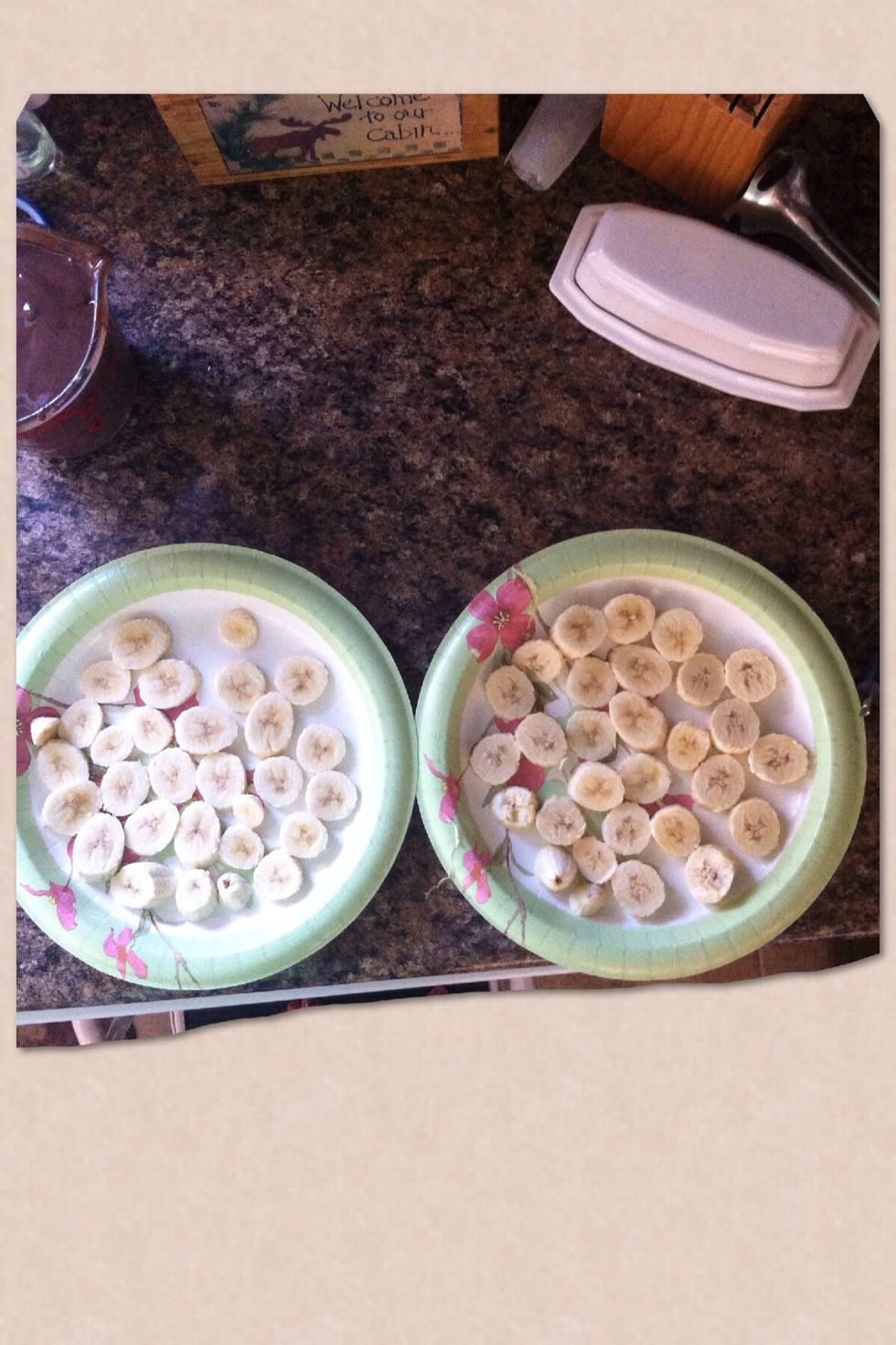 Once all the bananas are cut up place them on a plate, in one flat row with none on top of each other.