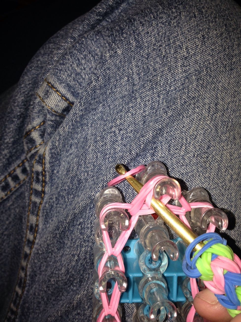 Once all the bands are loomed it's time to close of the charm. Put your hook through the bands. Place your last band on the end of the hook.