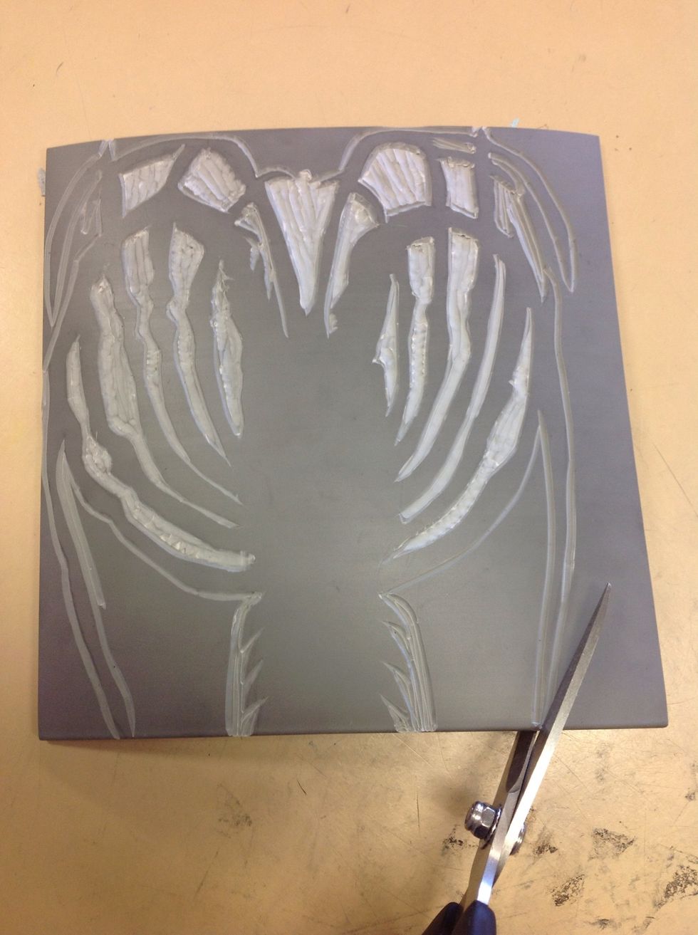 Once all the inside areas are carved out, use scissors to cut out the larger outer area.