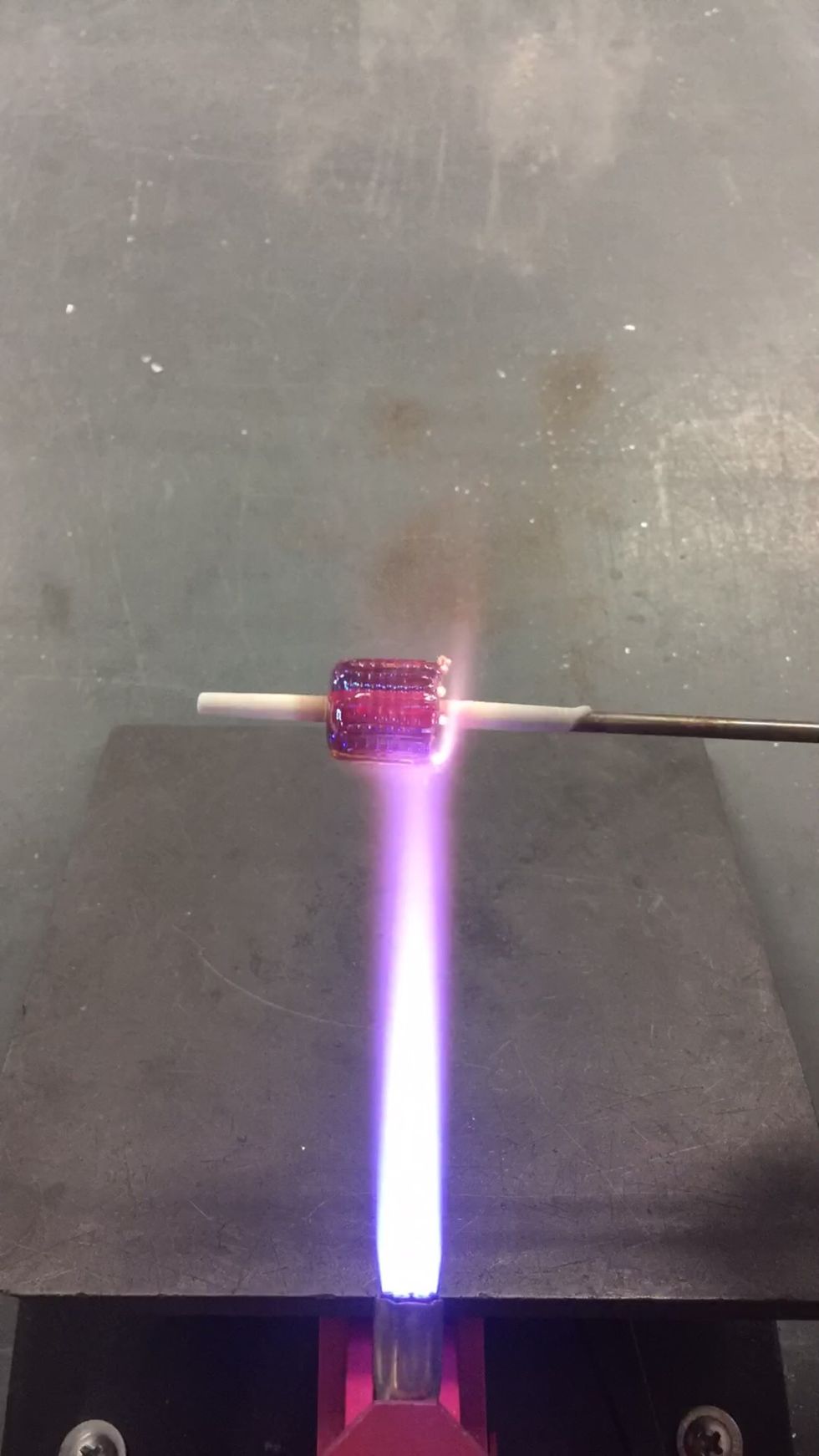 Once all the stripes have been applied, heat the ends of the bead to smooth it out.