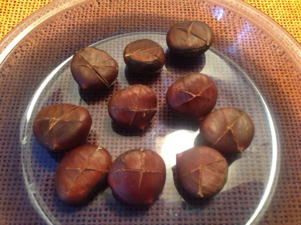 Once an "X" is cut into each, place the chestnuts in a shallow pan or on a baking sheet. Place pan in the oven for 20-30 minutes and roast until tender and the shell comes off easily.
