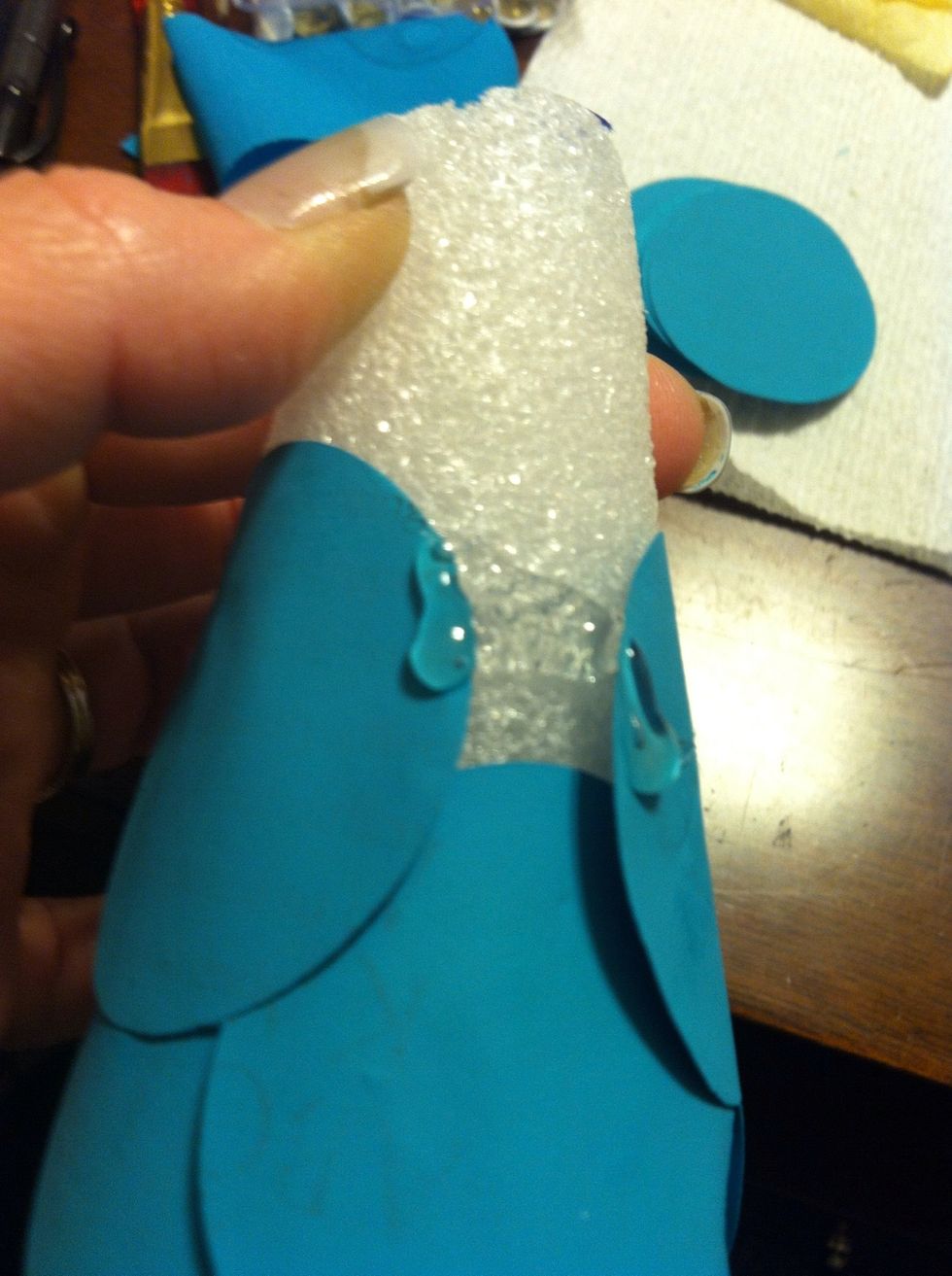 Once at the top, apply glue to both the circles and the foam to close it up.