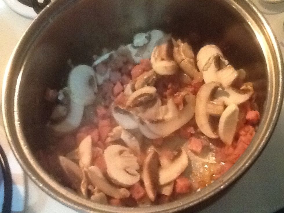 Once bacon has browned add mushrooms and cook for a couple of minutes