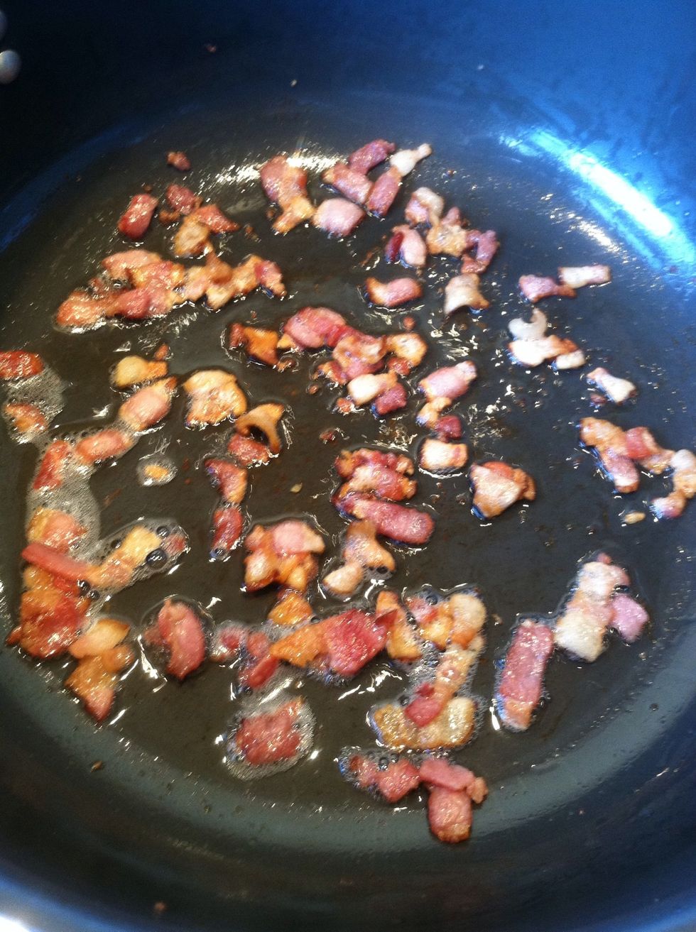 Once bacon starts to crisp add carrots and onions