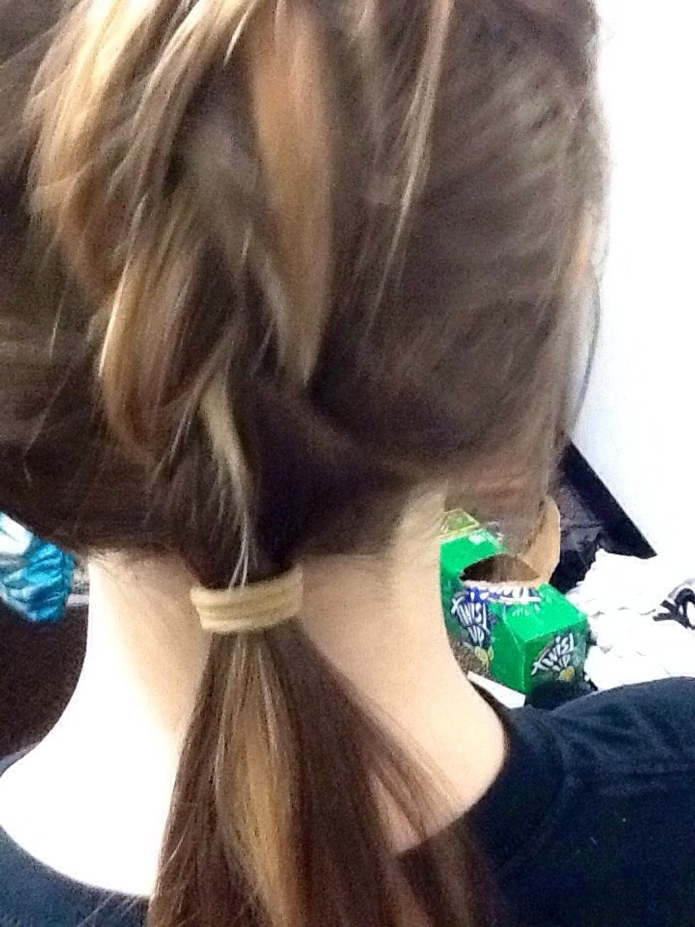 Once braid is finished gather all hair and fasten in a low pony tail