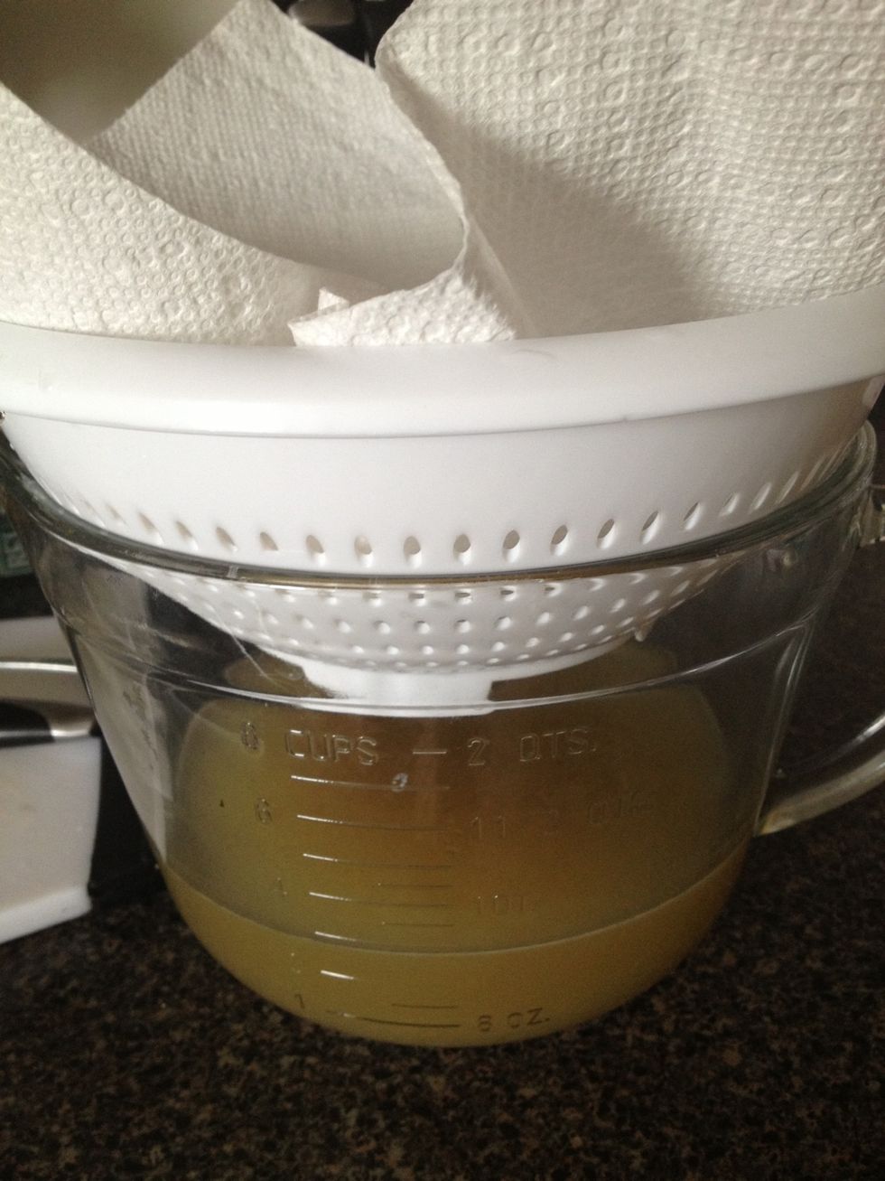 Once broth is done, put a lined strainer over a large bowl or measuring cup. I used a paper towel to line my strainer but you can use cheesecloth or a coffee filter.