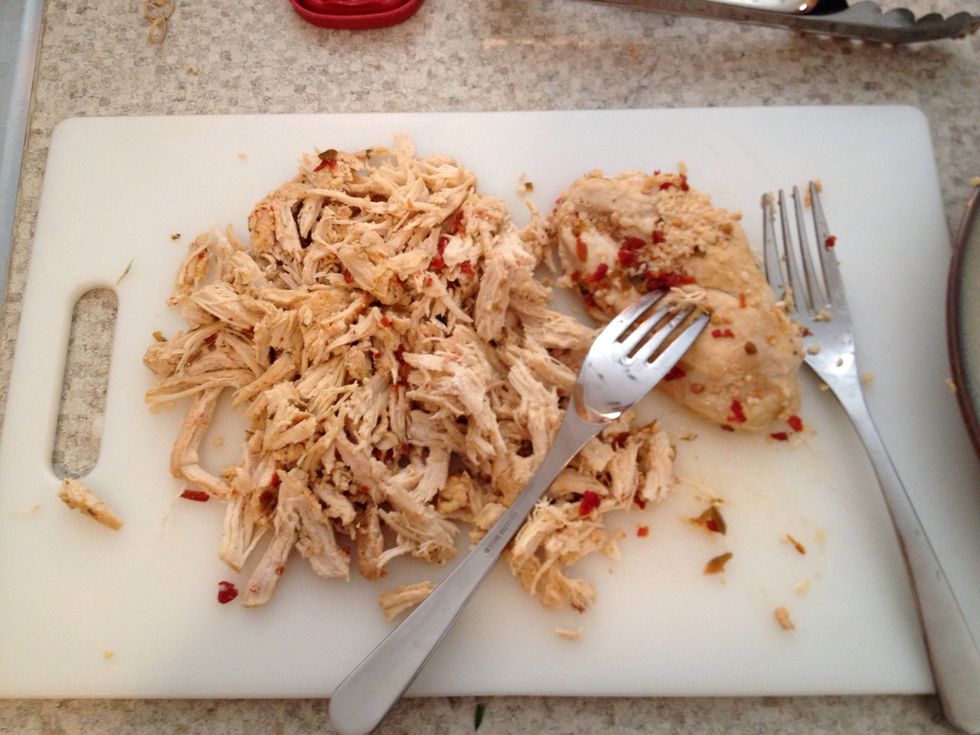 Once chicken is done cooking you can shred it  using two forks or your hands but you will need to shred all of it.