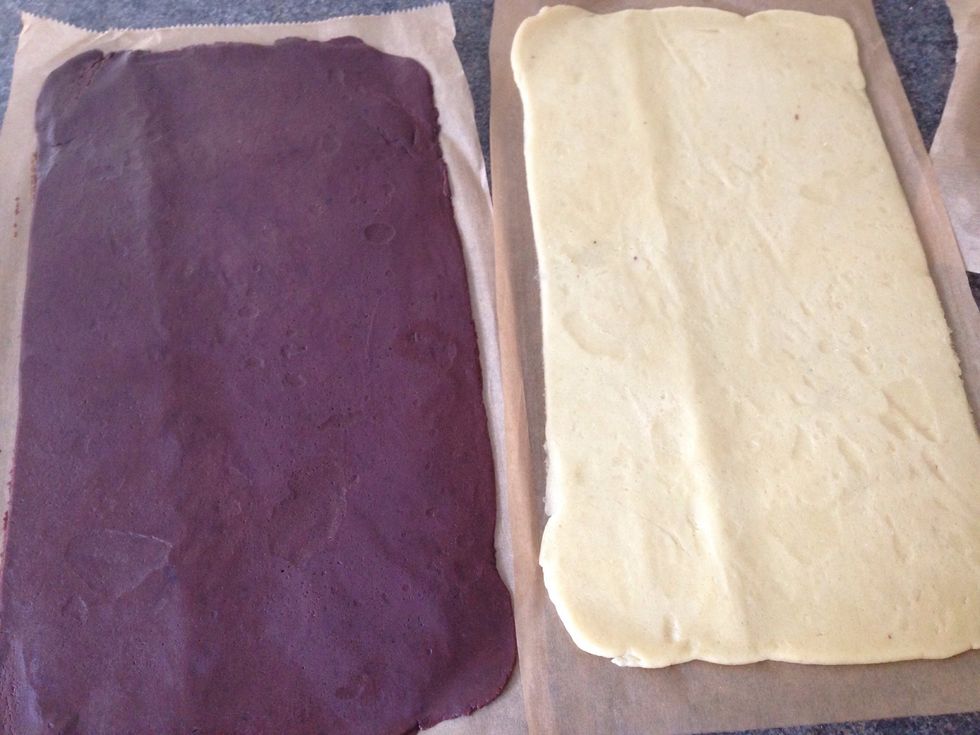 Once chilled, remove the top layers of parchment paper. Place the chocolate layer on top of the plain one.