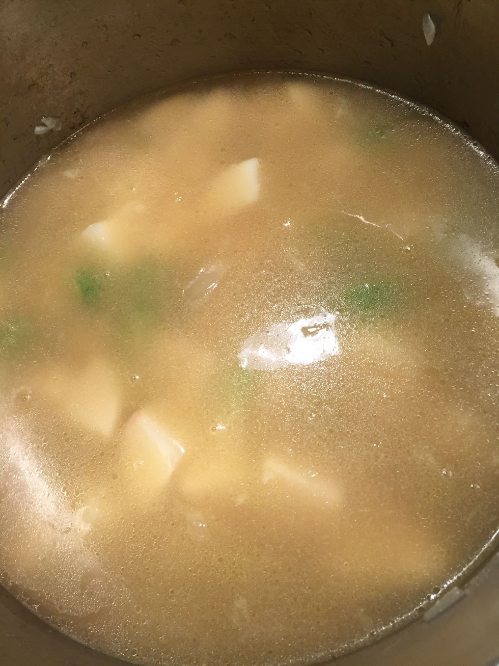 Once coated, add a carton of chicken broth (and a half of another one) or until potatoes are covered completely.