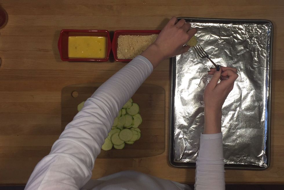 Once coated with both mixtures, place slices on greased pan.