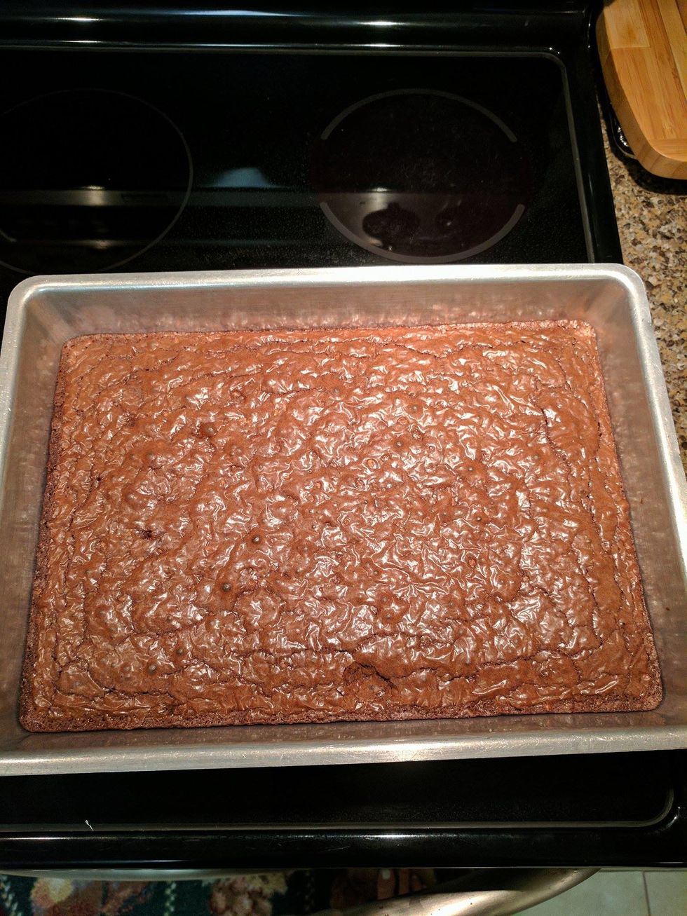 Once cooked, place the pan with the cooked brownies onto a trivet (heat-resistant surface) and allow the brownies to cool for an hour.