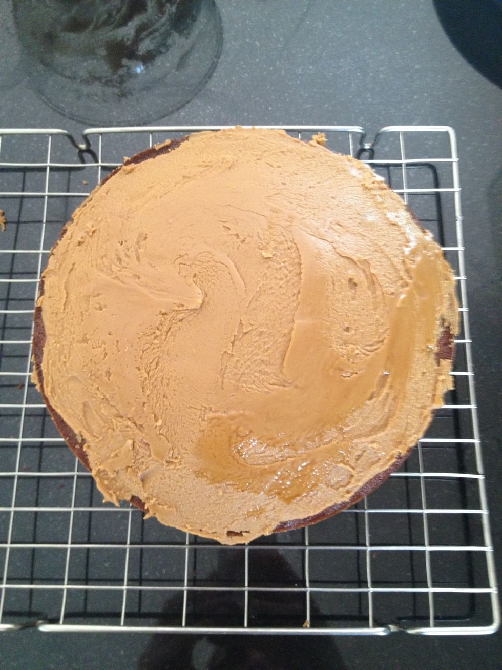 Once cool ice the bottom on one of the layers and the top of another. Place the one iced on top above the other (which should be flipped). And now your cake is complete. Enjoy.