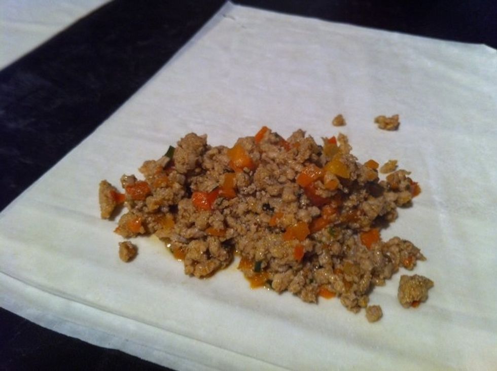 Once cooled place approx 1/4 cup of mixture on to 3 sheets of phyllo pastry. Phyllo dries fast so at this point you will need to work fast.