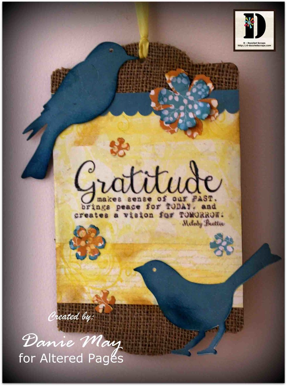 Once decorated your plaque is ready to hang. Tie a piece of coordinating seam binding through the center of the top of your panel. And your project is finished.