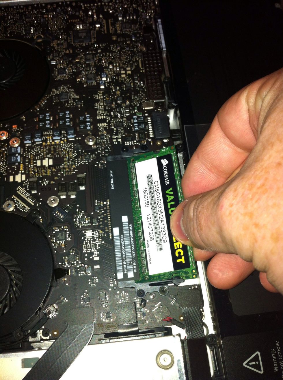 Once disconnected simply remove old memory and slot in the new memory. First push memory in slot then push down to clip into place